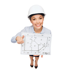 Image showing businesswoman in helmet with blueprint