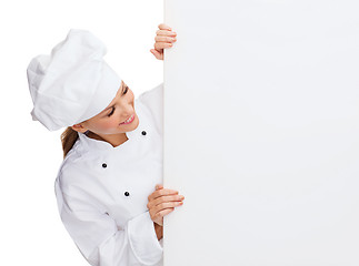 Image showing smiling female chef with white blank board