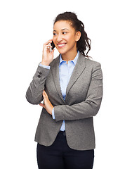 Image showing smiling woman looking at smartphone