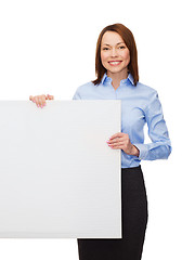 Image showing smiling businesswoman with white blank board