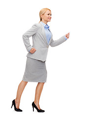 Image showing smiling businesswoman running