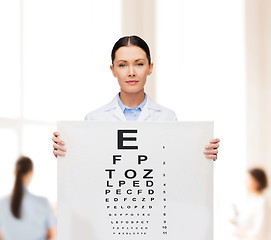 Image showing calm female doctor with eye chart