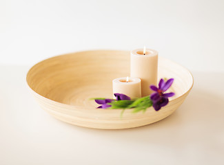 Image showing candles and iris flowers in wooden bowel