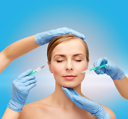 Image showing woman face and beautician hands with syringe