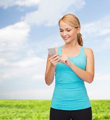 Image showing sporty woman with smartphone