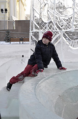 Image showing Portrait of the boy sitting on the edge of an ice slope.