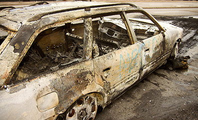 Image showing burnt-out car in city