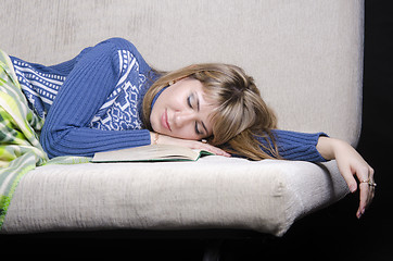 Image showing The girl fell asleep on sofa with a book