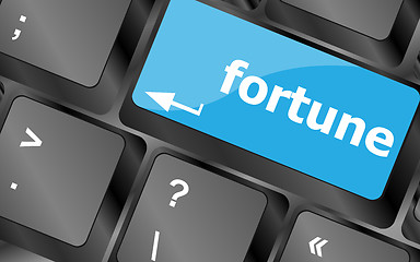 Image showing Fortune for investment concept with a orange button on computer keyboard