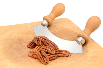 Image showing Pecan nuts with a rocking knife