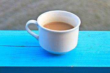 Image showing hot coffee in white cup on wooden