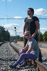 Image showing Two young men on train tracks