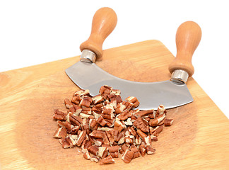 Image showing Chopped pecan nuts with a rocking knife