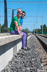Image showing Two men sitting on platform
