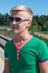 Image showing Stylish man with sun glasses on platform