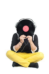 Image showing Man hiding his face with vinyl record