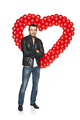 Image showing Man standing in front of heart shape