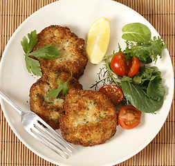 Image showing Fish cakes and salad high angle