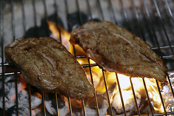 Image showing Angus steaks on a barbecue