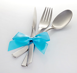 Image showing knife fork and spoon with blue ribbon