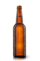 Image showing Beer bottle with water drops isolated on white