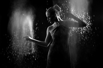 Image showing Woman With Stop Motion of Explosive Powder Captured by Flash