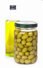 Image showing Green olives preserved in bank and a bottle of olive oil