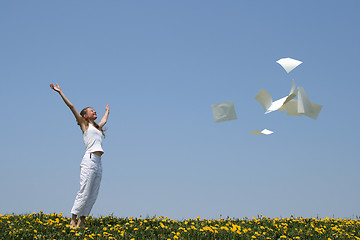 Image showing Laughing girl frees herself from paperwork