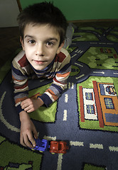 Image showing Child is playing with cars