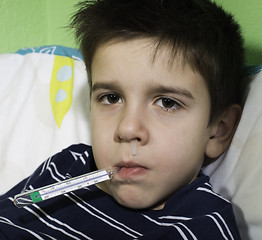 Image showing Sick child in bed.