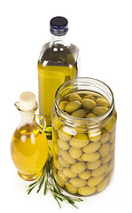 Image showing Green olives preserved in bank, bottle of olive oil, rosemary