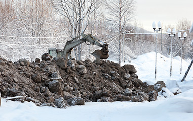 Image showing Excavator digging frozen ground 