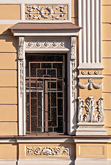 Image showing A window with a bas-relief and grating.