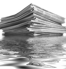 Image showing sinking stack of newspapers