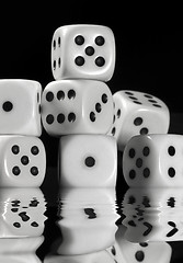 Image showing sinking pile of white dice