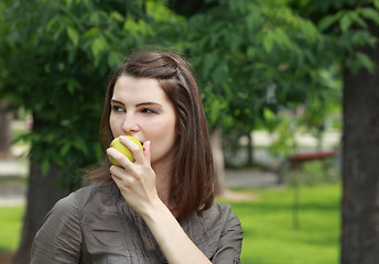 Image showing Portrait of a Woman Eating a Green Apple