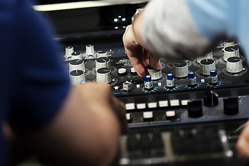 Image showing Hands on a sound mixer