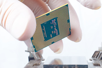 Image showing Human hand holding modern processor