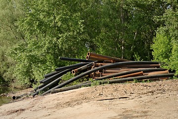 Image showing Rusty metal pipes in the forest