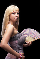 Image showing Beautiful young woman with fan