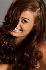 Image showing young woman portrait with shiny healthy brown curly hair