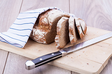 Image showing homemade fresh baked bread and knife 