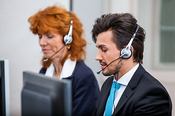 Image showing friendly callcenter agent operator with headset telephone 