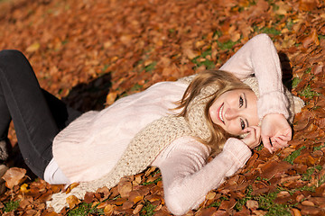 Image showing young smiling woman with hat and scarf outdoor in autumn