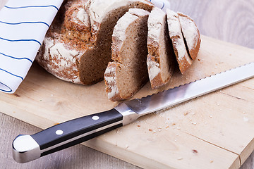 Image showing homemade fresh baked bread and knife 