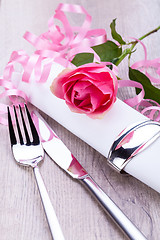 Image showing Table setting with a single pink rose