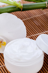 Image showing cosmetic face cream on wooden background 