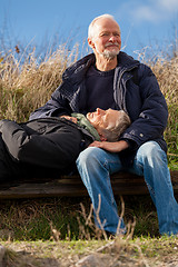 Image showing happy senior couple relaxing together in the sunshine