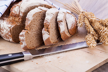 Image showing homemade fresh baked bread and knife 