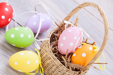 Image showing colorful easter egg decoration on wooden background